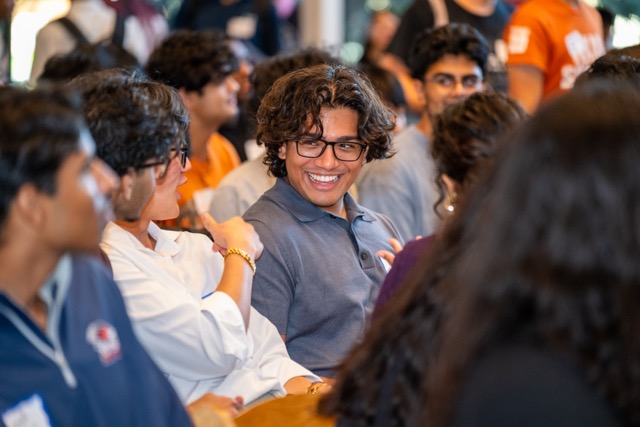 A crowd of Fest attendees sharing a laugh between sessions