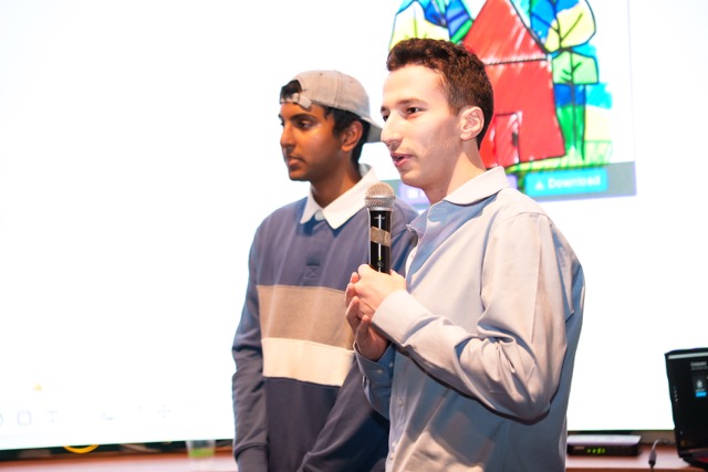 Two attendees on the mic presenting their project to the room