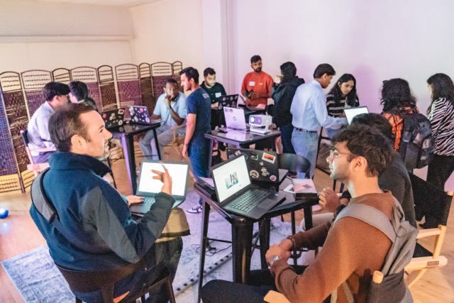 A room of attendees mid-build at their laptops